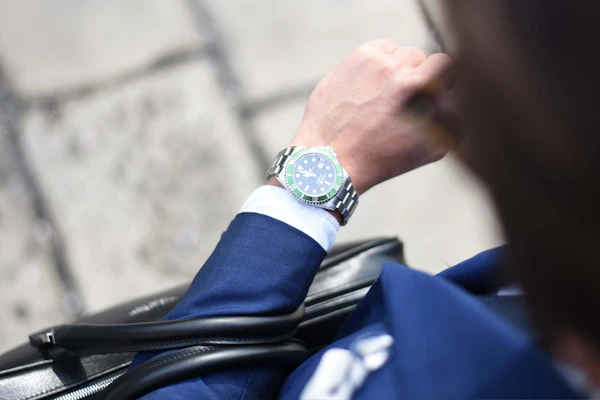 Image of a man with a suit and expensive watch