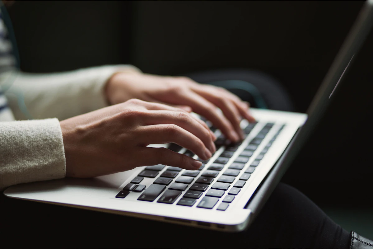 Image of woman working with laptop in her lap