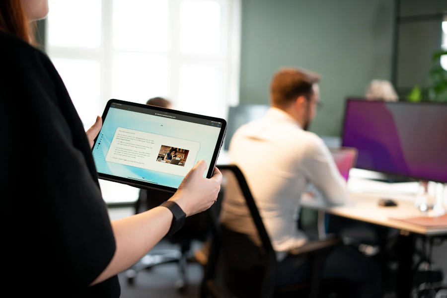 Woman holding tablet in open office space