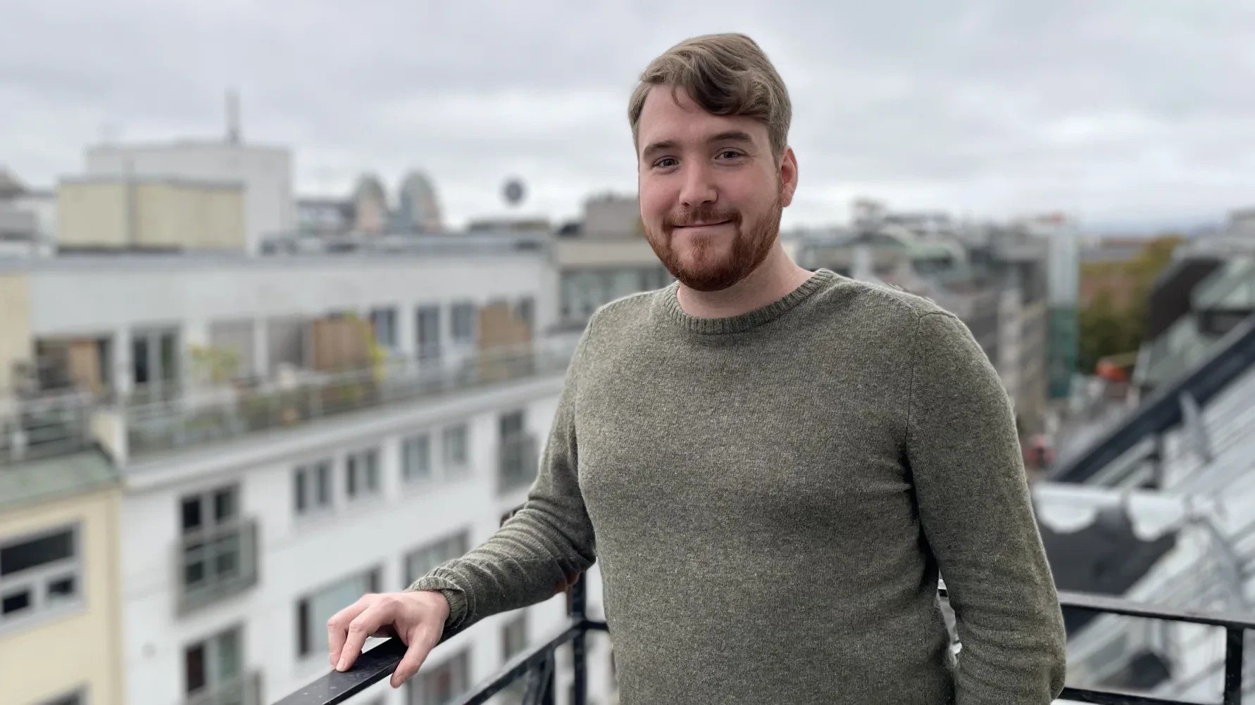 Portrait of Joakim Hvalby, male in his 30's, outside on balcony