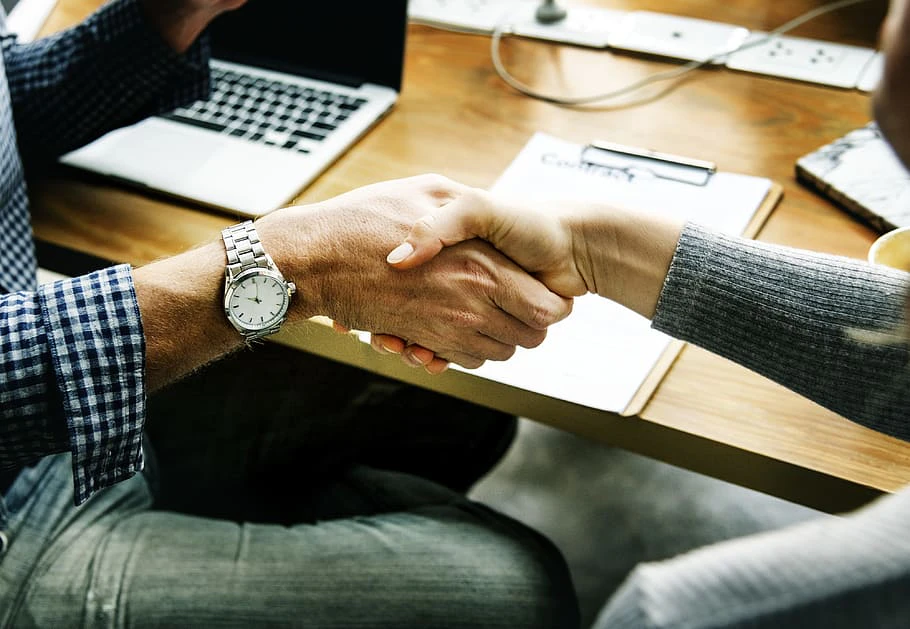 Handshaking between a man and a woman in office