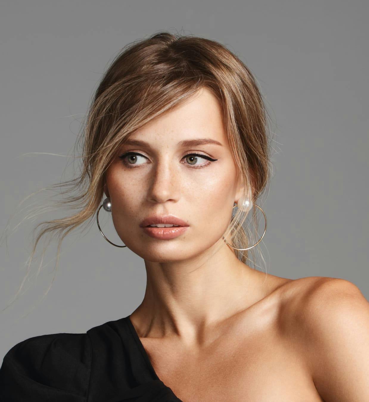 Woman with dirty blonde hair looking off to the left.