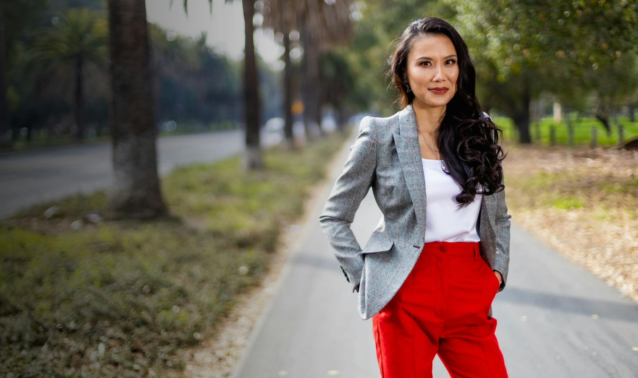 Dr. Graw standing outside with red pants on and a gray blazer