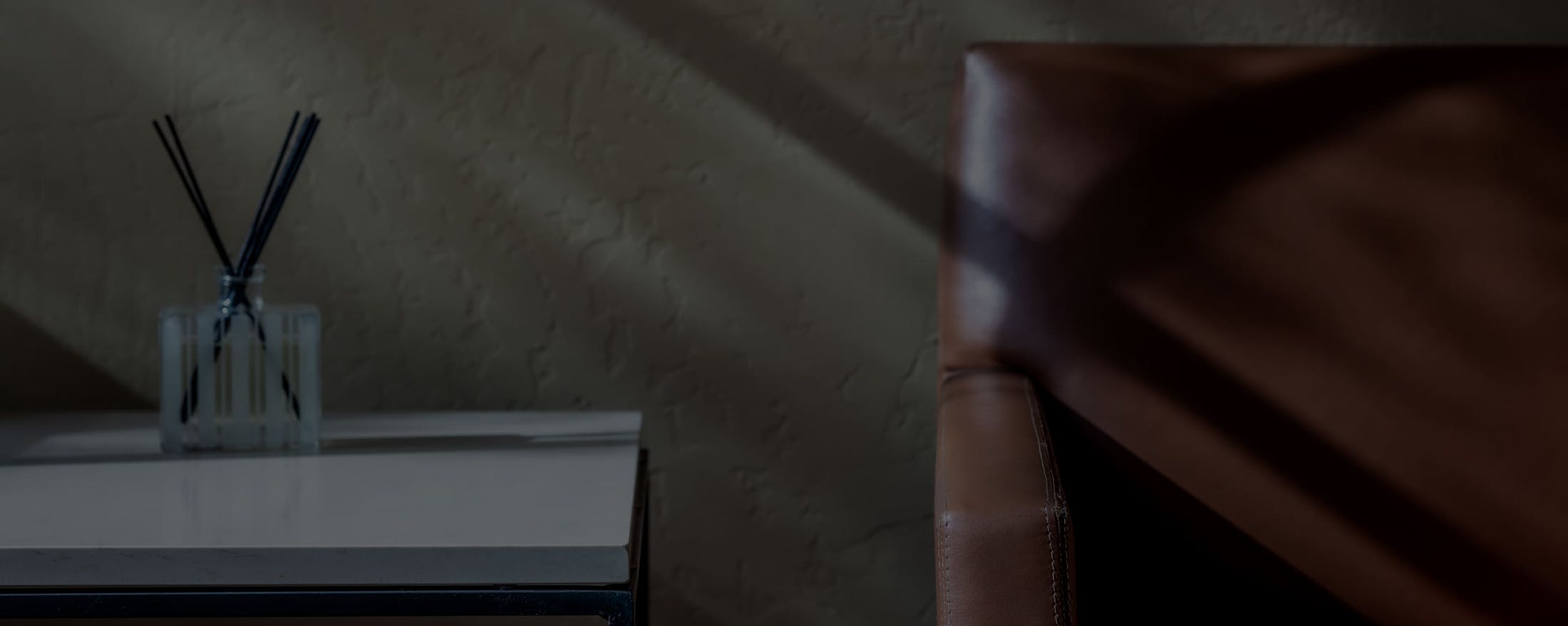 a chair and a desk with incense on it