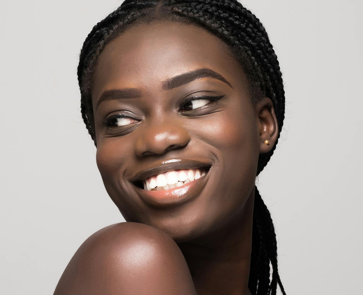 woman with black long braids smiling