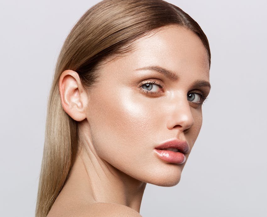 woman with hair tucked behind her ear