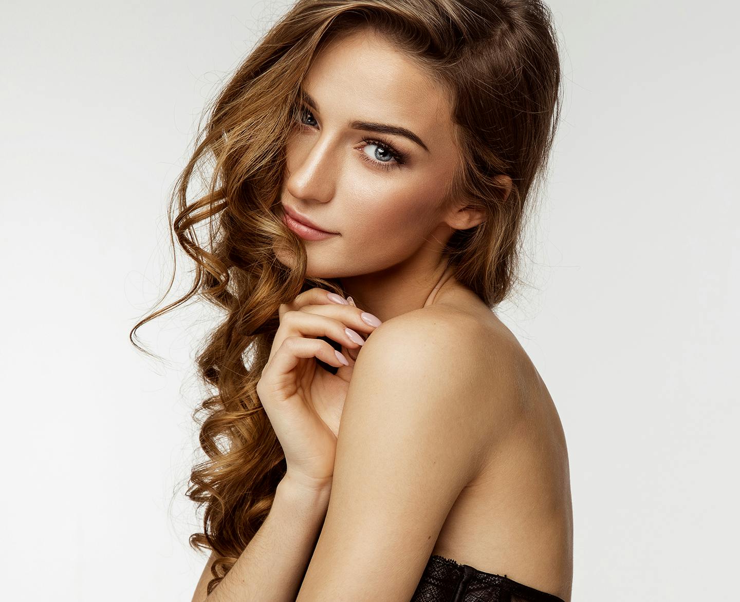 woman with strapless dress on and curly brown hair