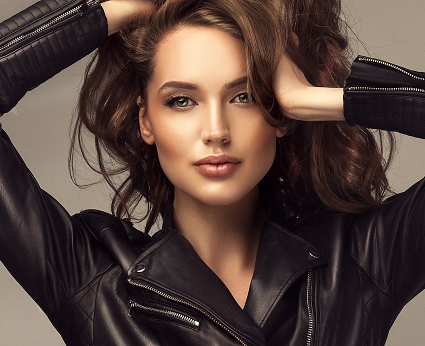 woman with brown hair and leather jacket on