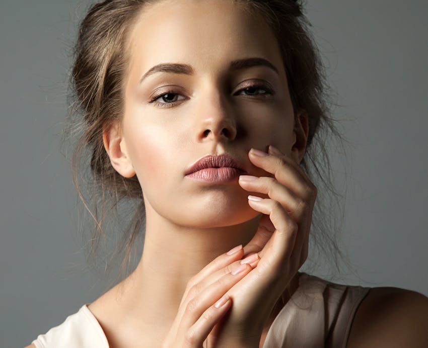 woman with brown hair and pink lipstick on
