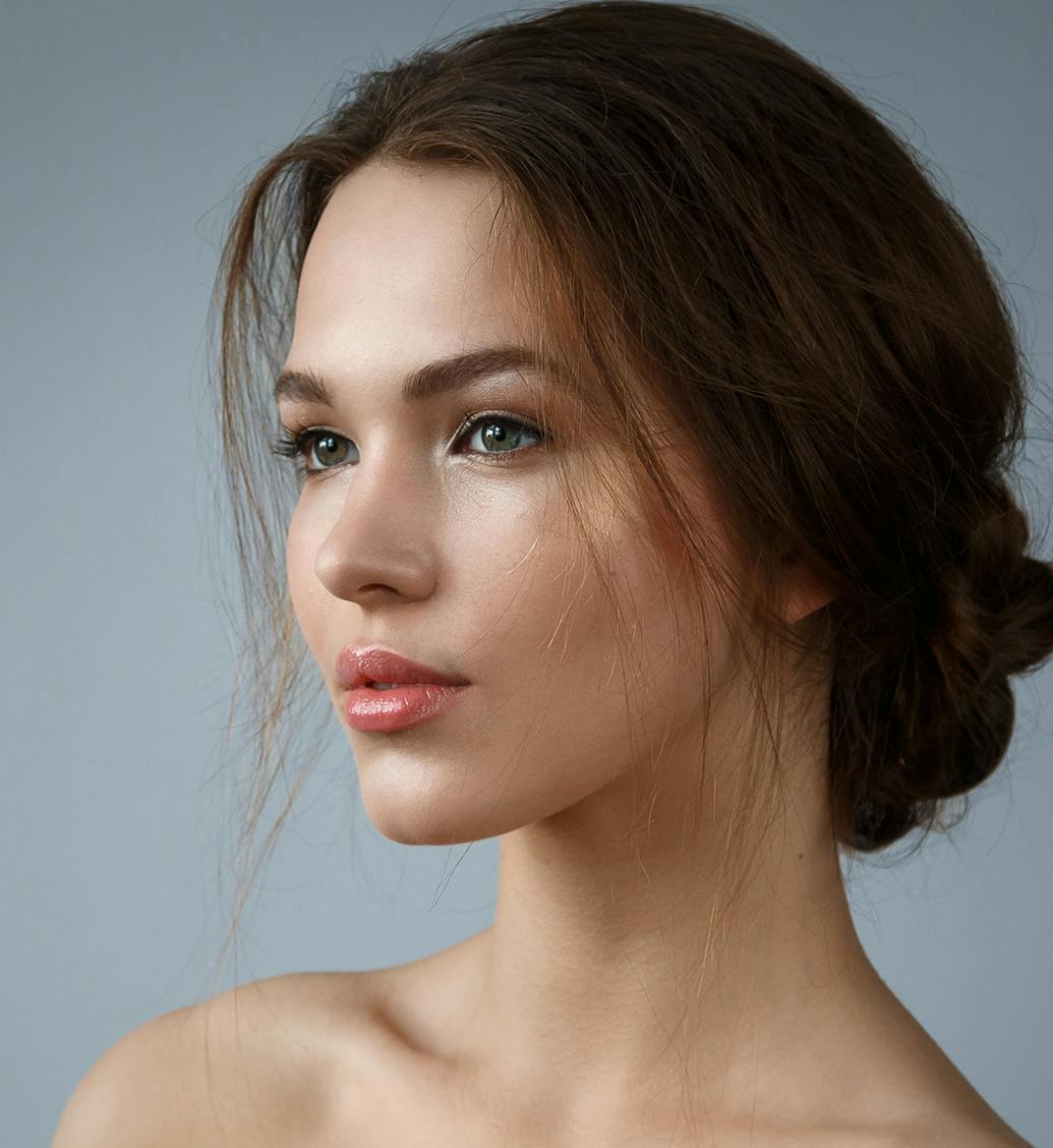 woman with brown hair in a low bun