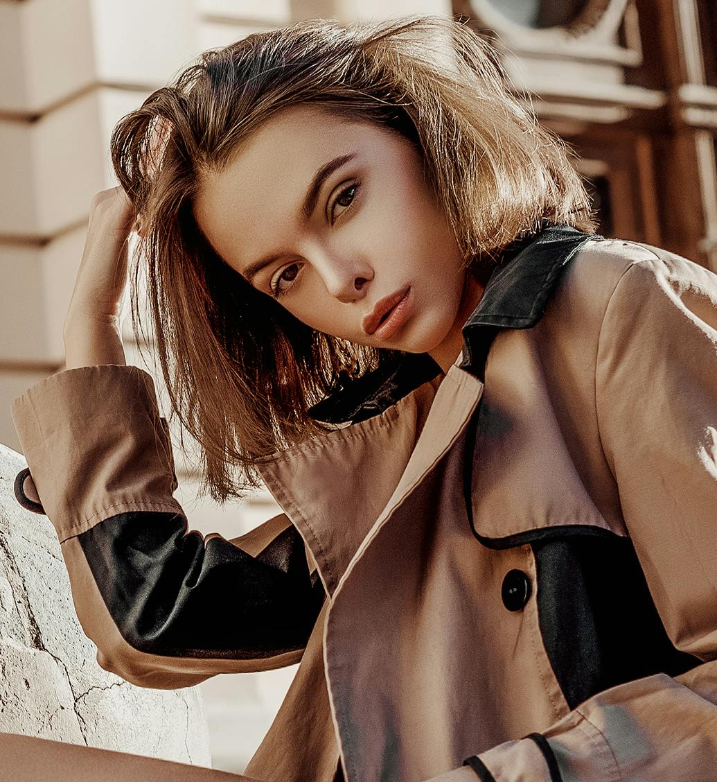 woman in brown jacket and short brown hair