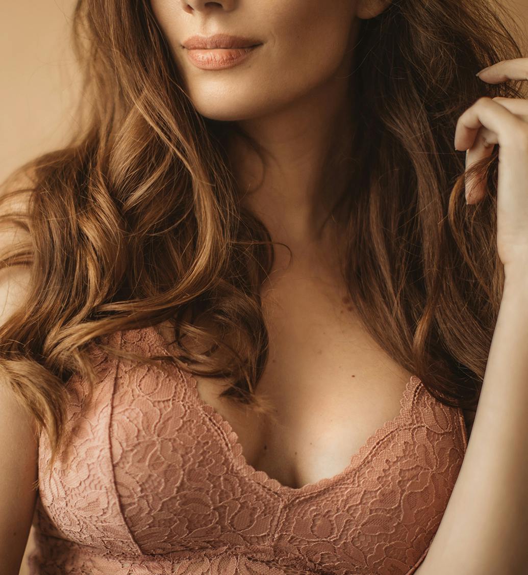 woman with lace rose colored bra on