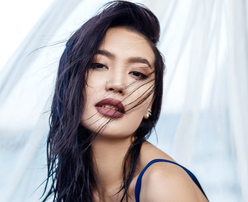 Woman with a blue tank top and dark hair