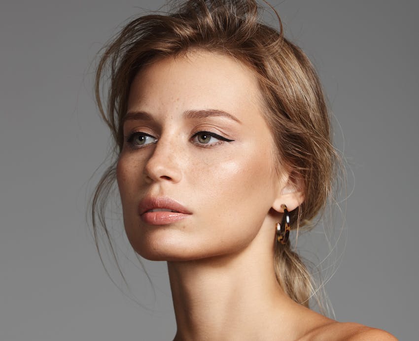 woman with her hair tied back and black eyeliner on