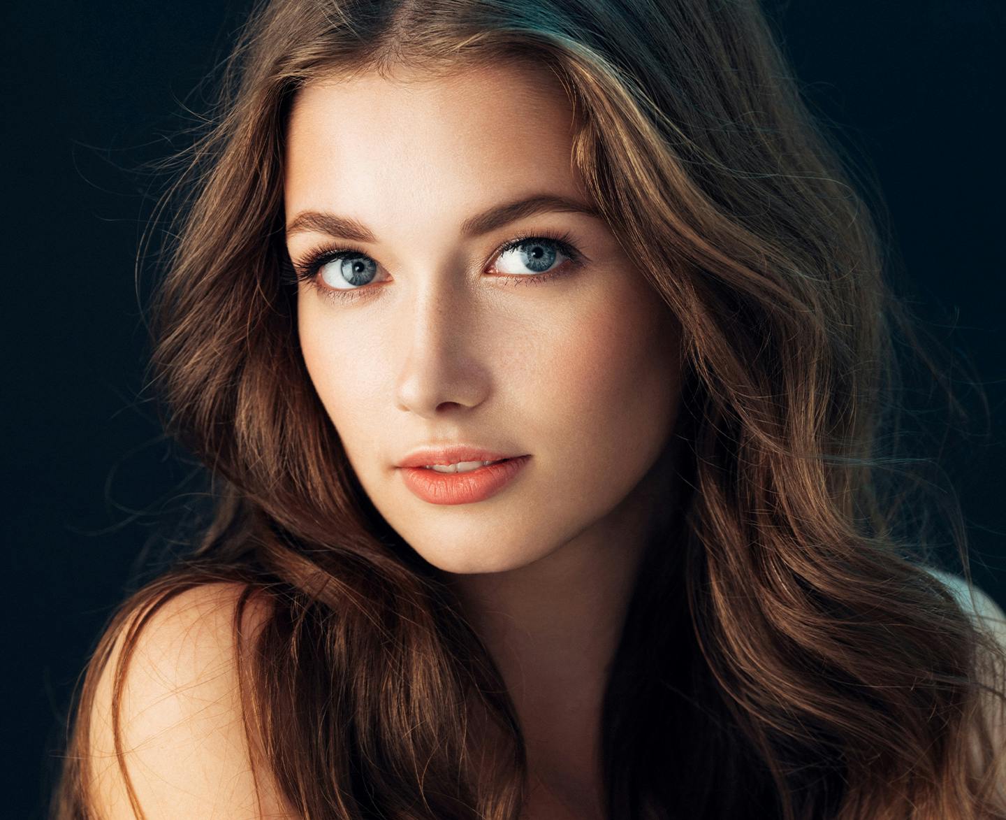 woman with long brown hair and blue eyes