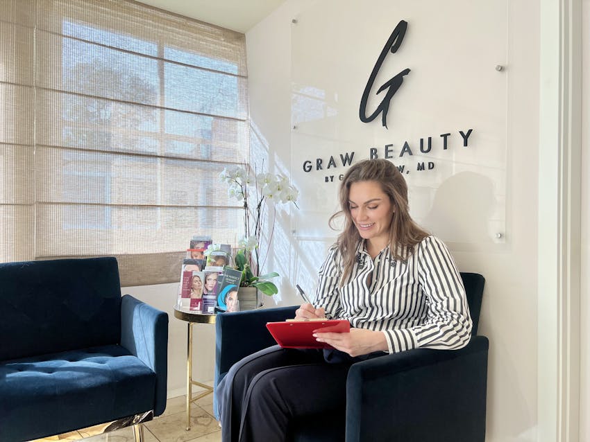 Female holding a clip board and smiling