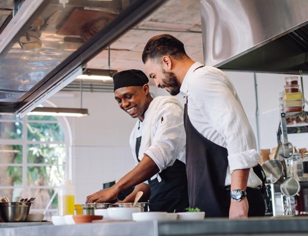 Peninsula Group Limited - Two line chefs plating a dish