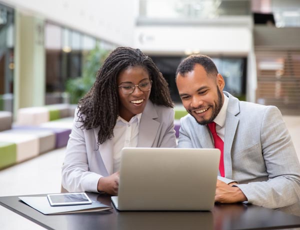 Peninsula Group Limited - An employer presenting information on a laptop to their staff