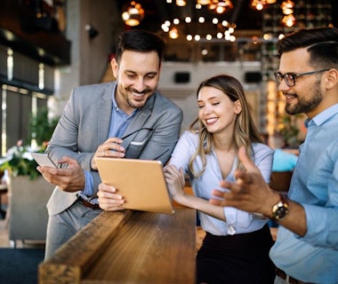 Peninsula Group Limited - Three employers using BrightHR software on a computer tablet