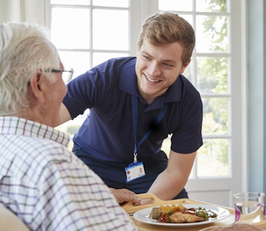 Carer and caree laughing together