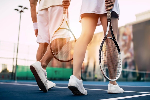 Two people playing tennis