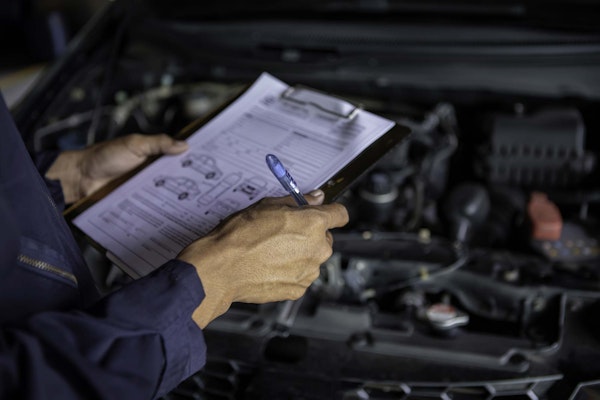 mechanic reviewing a car checklist