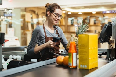 Employee scanning items at a checkout