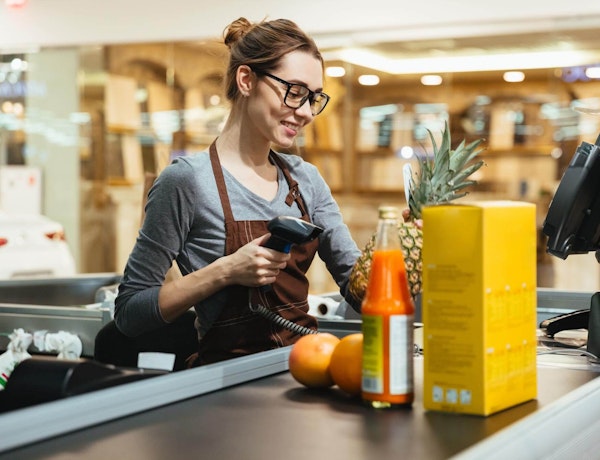 Employee scanning items at a checkout