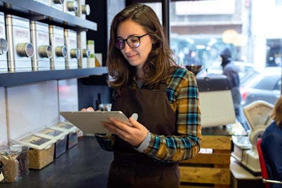 a retail worker looking at a computer tablet