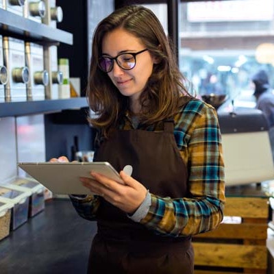 a retail worker looking at a computer tablet