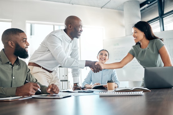 two employees shaking hands