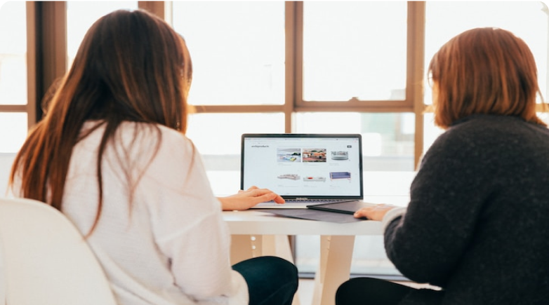 Two people looking at a laptop computer