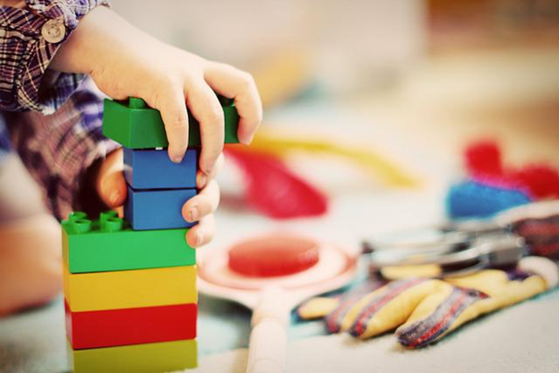 A toddler playing with building blocks.