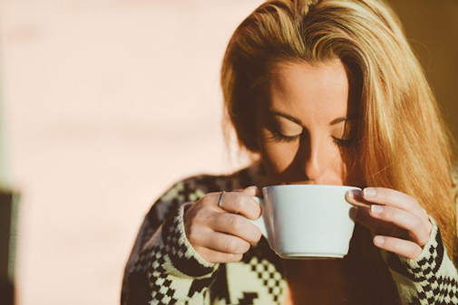 Someone having a hot drink whilst they are ill.