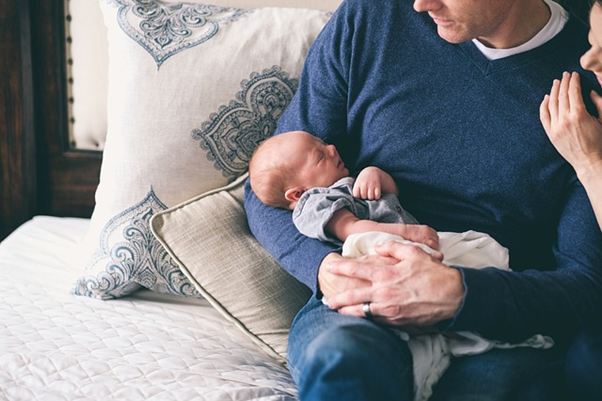 Someone holding a baby.