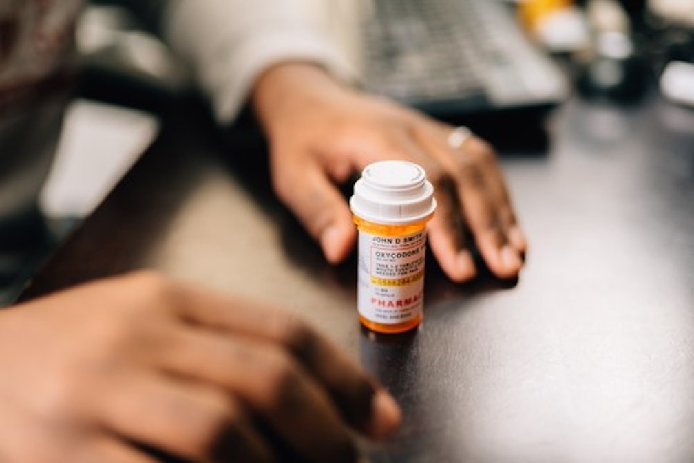 A person taking their medication following an appointment.