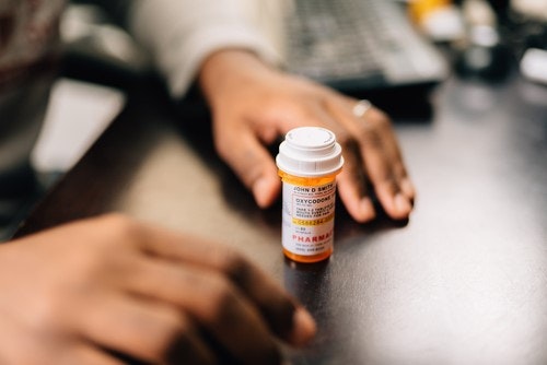 A person taking their medication following an appointment.