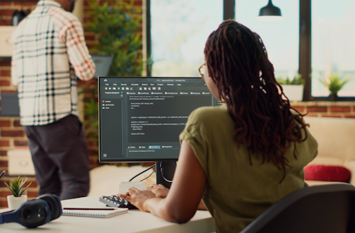 The image shows a lady looking at a computer screen.
