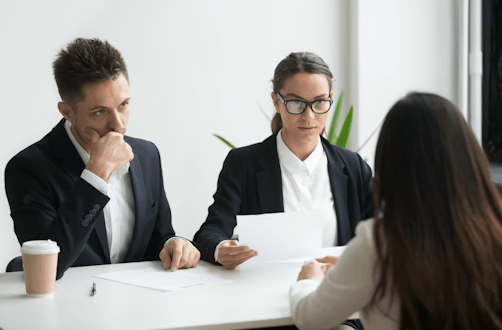 Three office workers sat around a table.