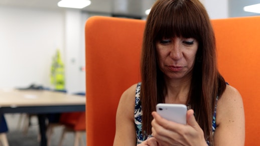 A woman looking at her phone.