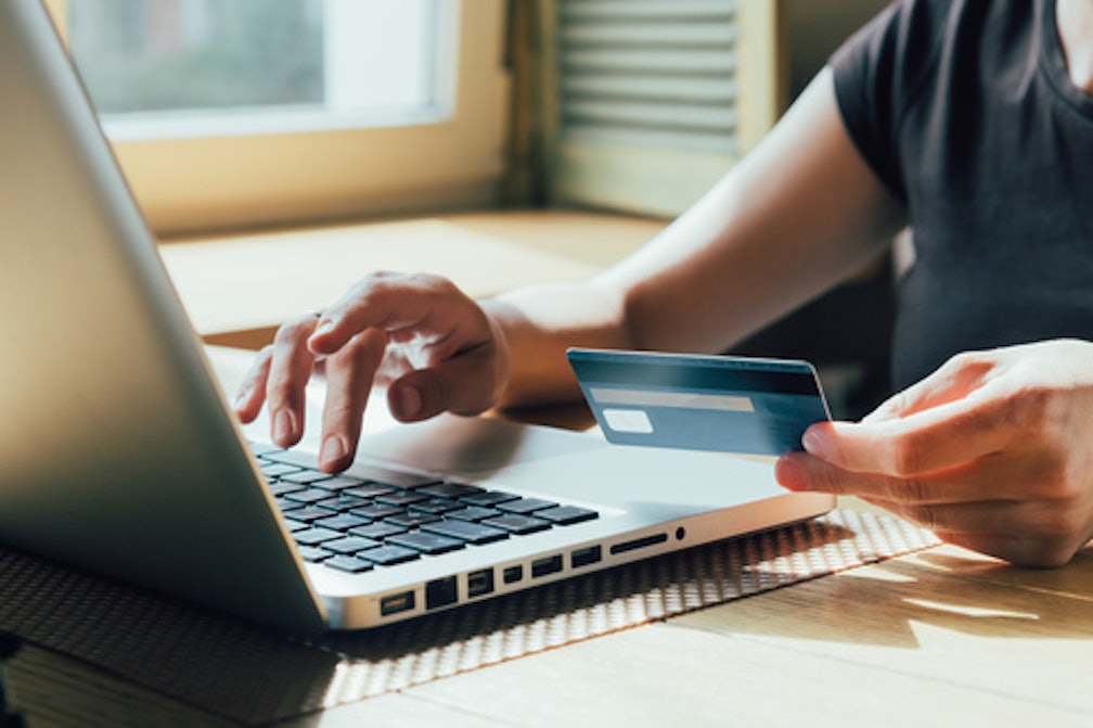 Someone paying for something online with a card
