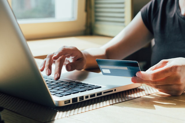 Someone paying for something online with a card