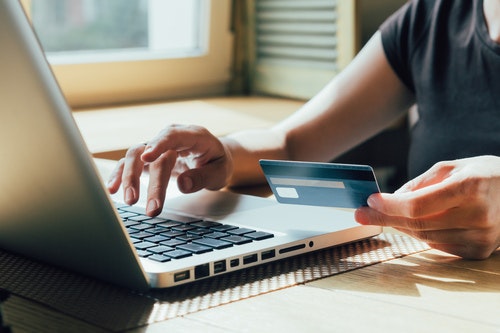 Someone paying for something online with a card