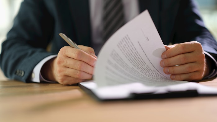 Someone signing an employment contract.