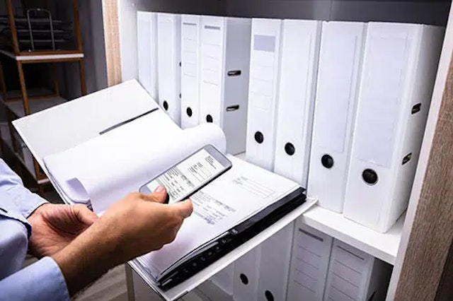 a person taking a picture of a document
