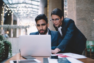 Two workers looking at their pay wages.