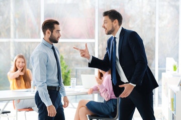 a man shouting at another man in work