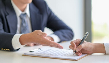 An employee signing a non-disclosure agreement.