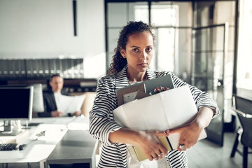 a woman with a box of belongings