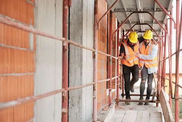 One injured worker being carried by a colleague